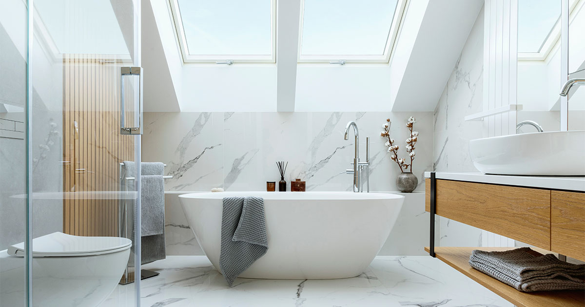 A beautiful bath with wood vanity and freestanding tub