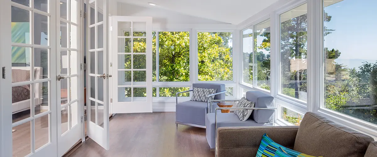 A sunroom addition with chairs