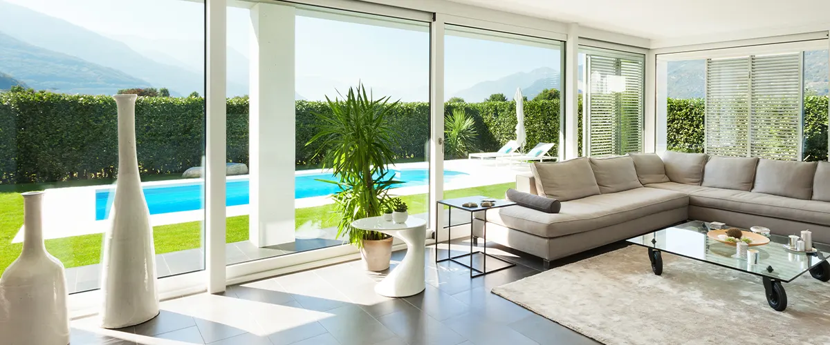 living room with big windows and pool view