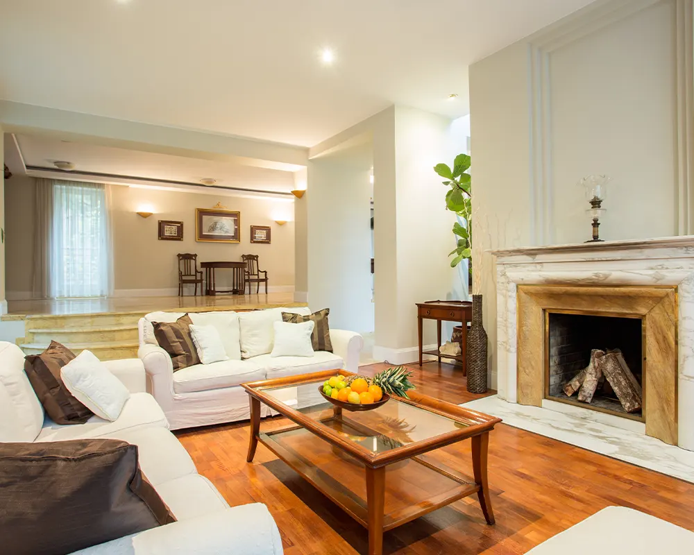 living room with white furniture and fireplace to determine remodeling cost