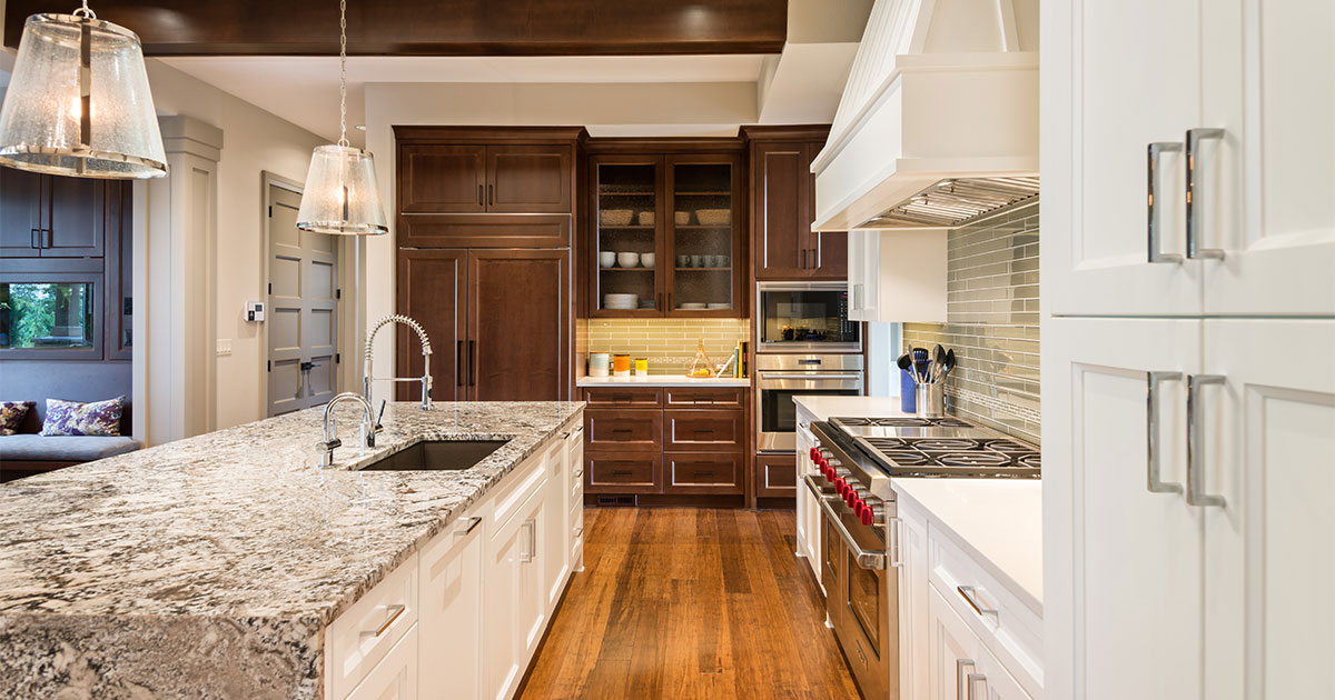 Granite countertop with wood kitchen cabinets and wood flooring in a kitchen remodeling cost in Arcadia, CA