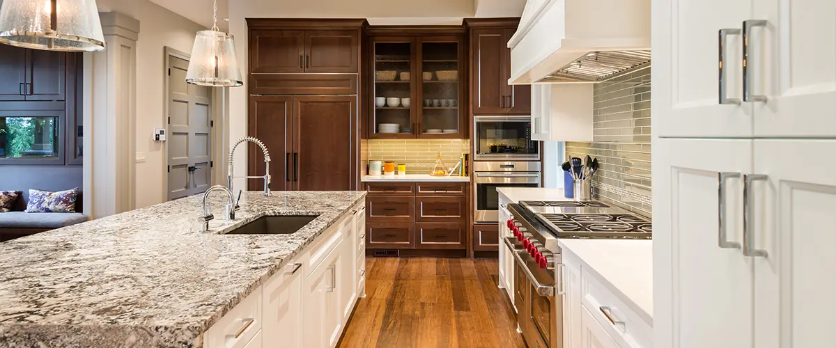 Granite countertop with wood kitchen cabinets and wood flooring in a kitchen remodeling cost in Arcadia, CA