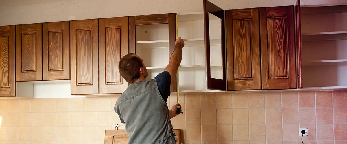 Man installing kitchen cabinets