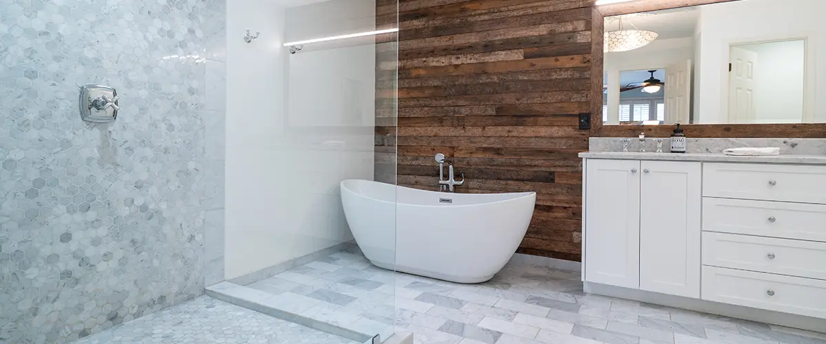 Glass walk in shower with a freestanding tub