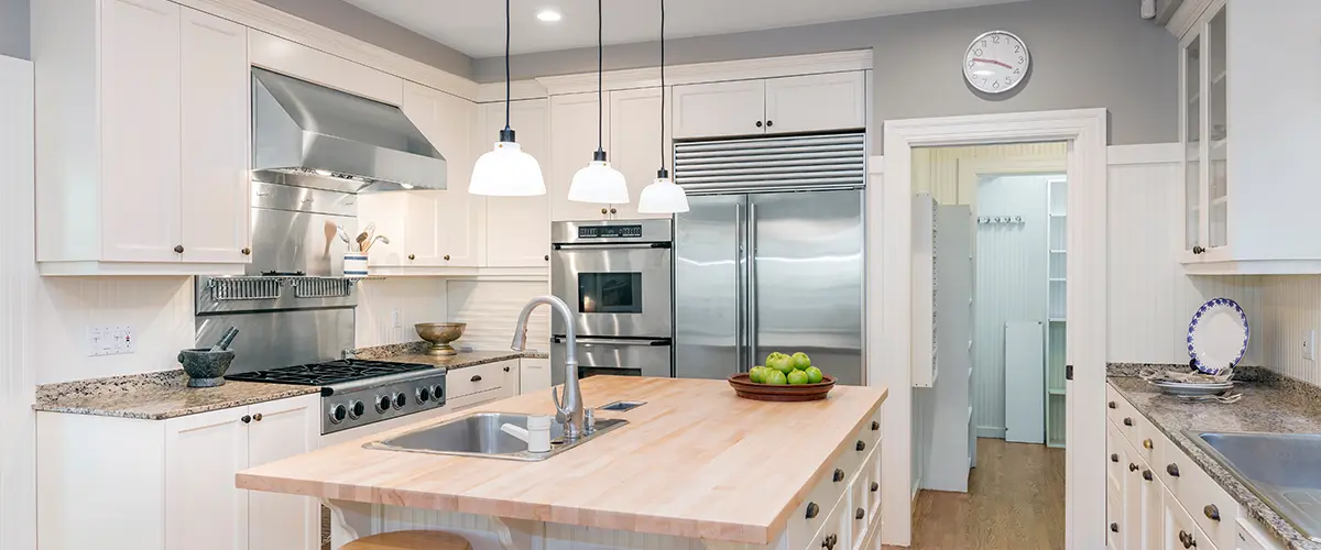 Amazing Luxury Kitchen Interior in white with wooden floor and kitchen island.