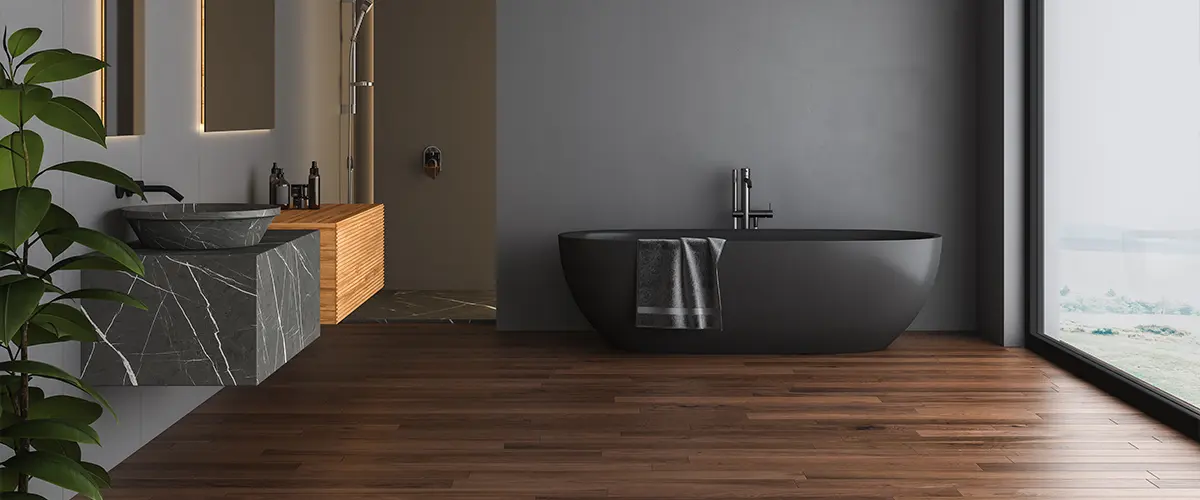 Dark bathroom interior with black parquet floor, black bathtub, black toilet and square mirrors, shower, front view. Minimalist black bathroom with modern furniture.