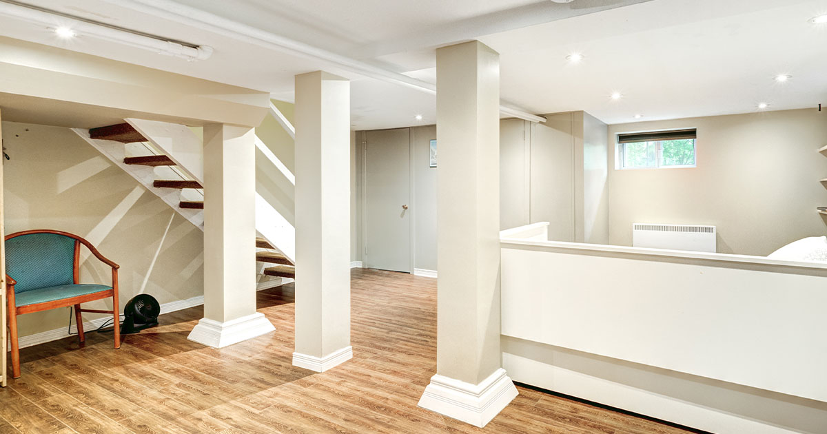 large basement with white walls and wooden floor