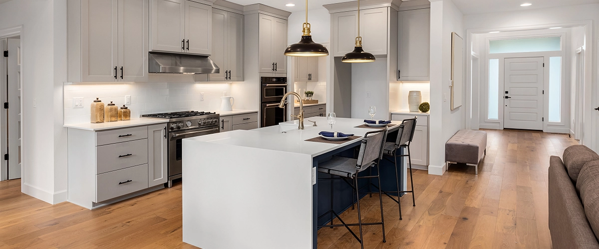 Beautiful kitchen in new luxury home with waterfall island, quartz counter tops