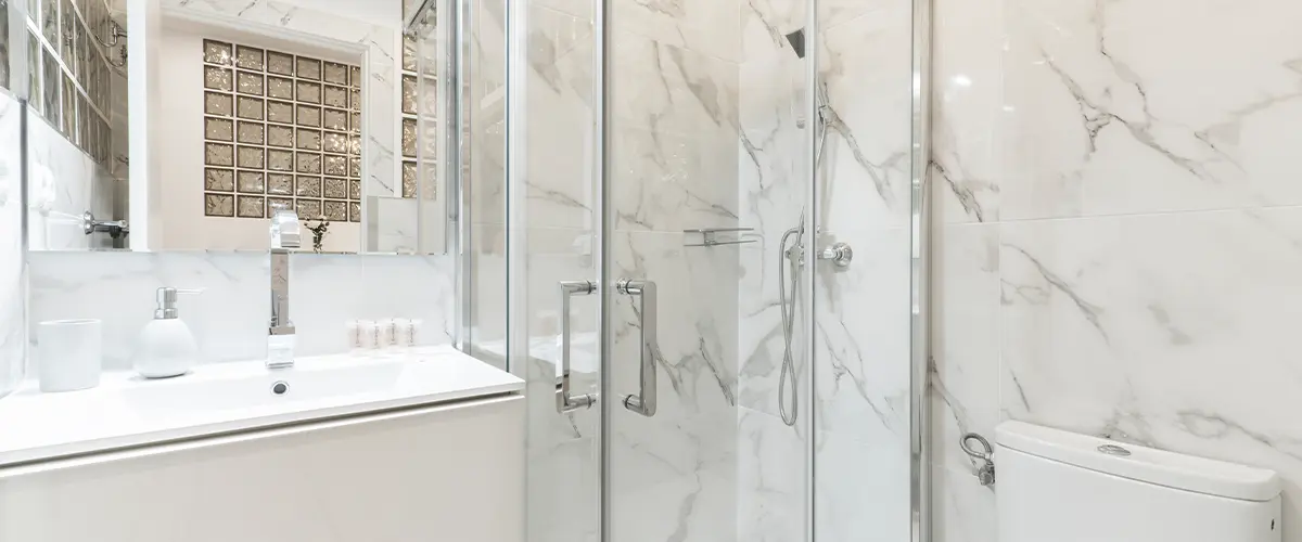 Luxurious marble-tiled bathroom with a glass-enclosed shower