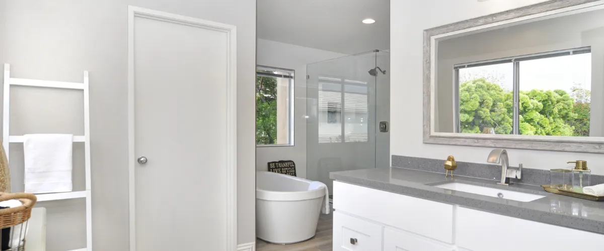 Modern bathroom featuring freestanding tub and glass-enclosed shower