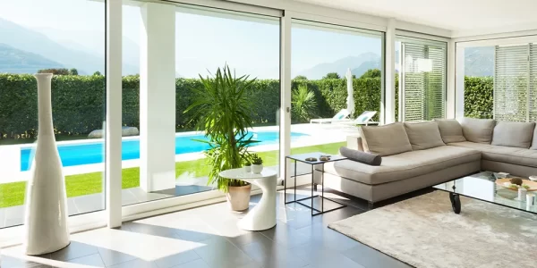 living room with big windows and pool view